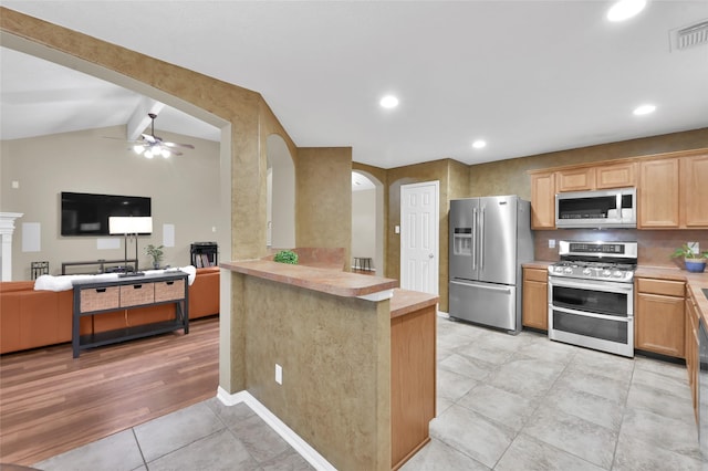 kitchen with visible vents, a ceiling fan, open floor plan, stainless steel appliances, and light countertops