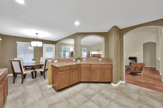 kitchen featuring light countertops, plenty of natural light, and pendant lighting