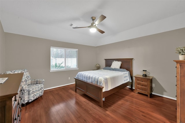 bedroom featuring visible vents, ceiling fan, baseboards, vaulted ceiling, and wood finished floors