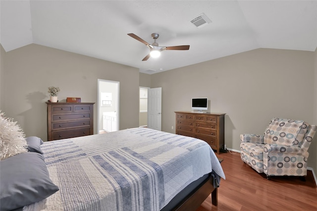 bedroom with a ceiling fan, lofted ceiling, wood finished floors, and visible vents