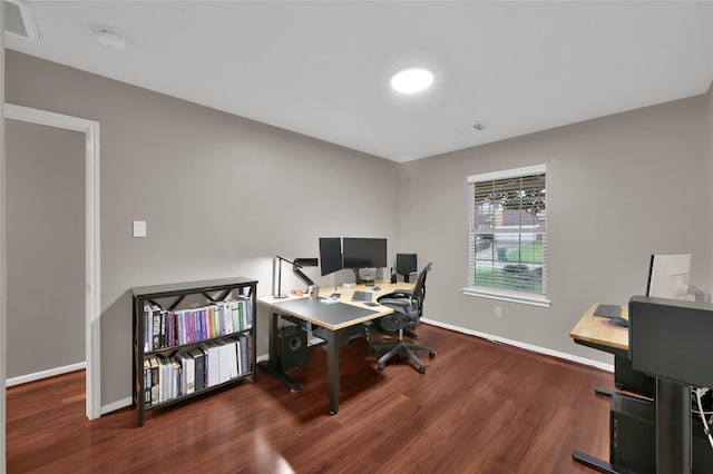 office area featuring visible vents, baseboards, and wood finished floors