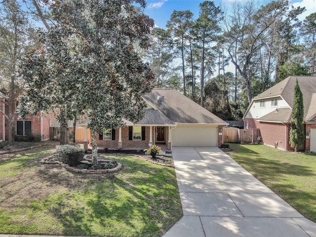 view of front of home featuring brick siding, a front lawn, fence, a garage, and driveway