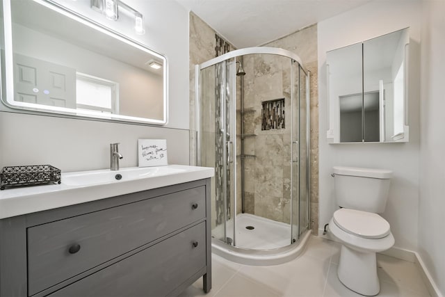 bathroom featuring vanity, toilet, baseboards, and a stall shower