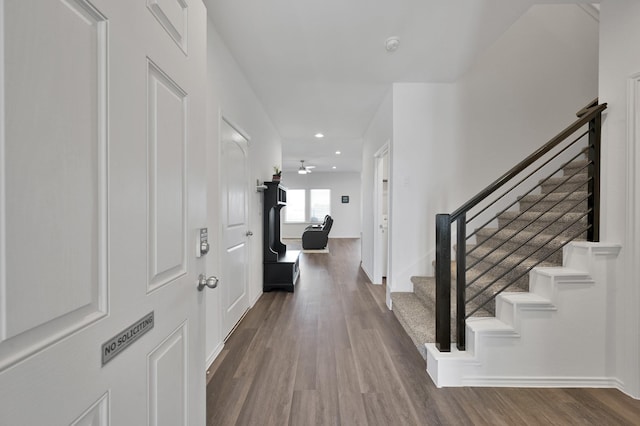 foyer entrance with recessed lighting, stairs, baseboards, and wood finished floors