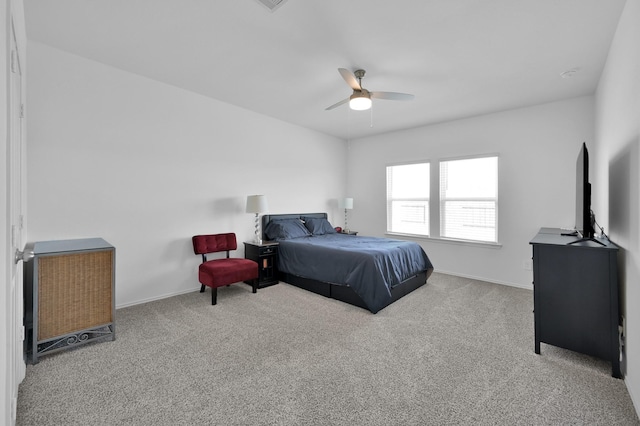 carpeted bedroom featuring a ceiling fan and baseboards