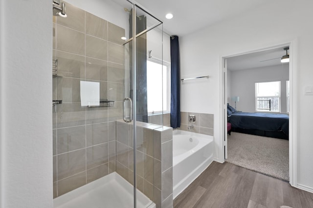 ensuite bathroom featuring a bath, connected bathroom, a stall shower, and wood finished floors