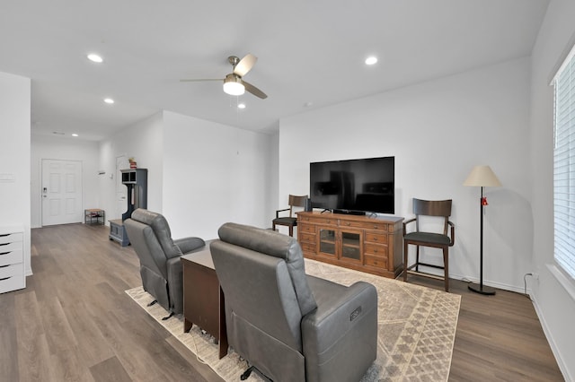 living area featuring recessed lighting, baseboards, ceiling fan, and wood finished floors