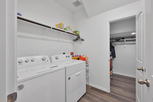 clothes washing area featuring baseboards, visible vents, dark wood finished floors, laundry area, and washer and clothes dryer