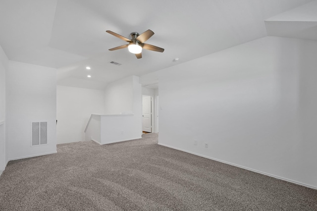 unfurnished room featuring lofted ceiling, visible vents, carpet floors, and ceiling fan