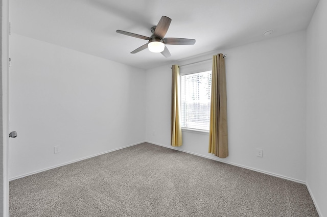 carpeted empty room with baseboards and ceiling fan