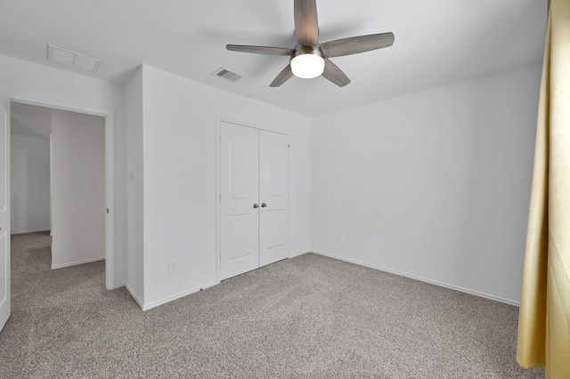 unfurnished bedroom with visible vents, carpet floors, a closet, and ceiling fan