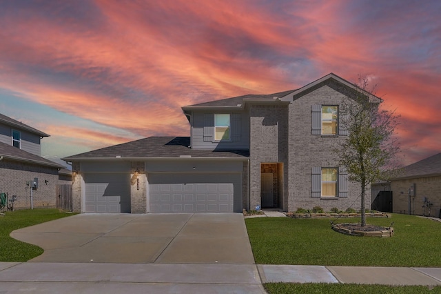 traditional home with a yard, a garage, and driveway