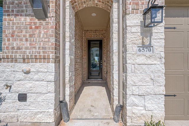 property entrance with brick siding