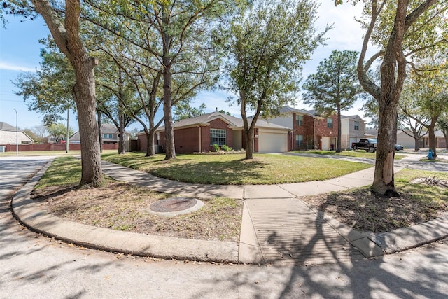 view of front of home featuring a front yard, a garage, and a residential view