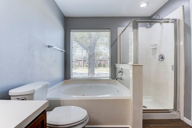 full bath featuring toilet, a stall shower, vanity, and a bath