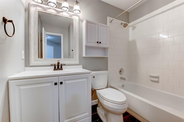 bathroom featuring vanity, toilet, shower / bathtub combination, and a textured wall