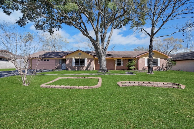 exterior space with brick siding, an attached garage, driveway, and a front lawn