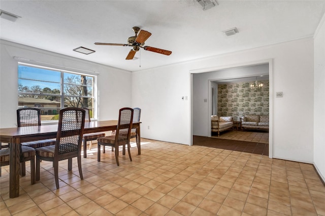 dining space featuring visible vents, ornamental molding, and ceiling fan with notable chandelier