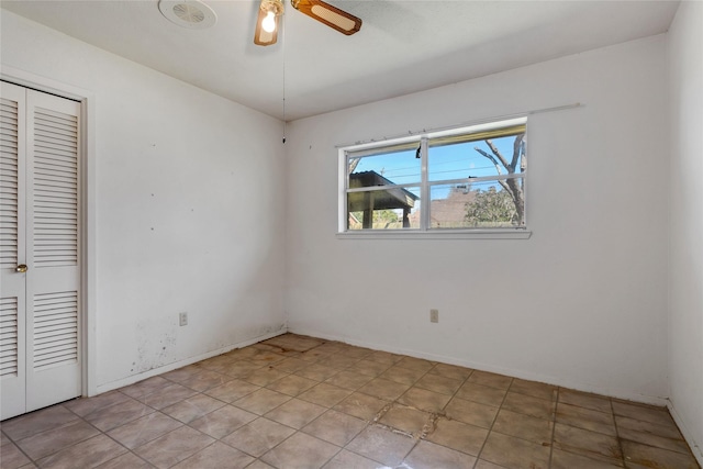 unfurnished bedroom with baseboards, a closet, and ceiling fan