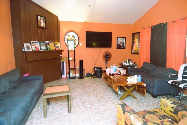 living room with stone finish flooring and vaulted ceiling