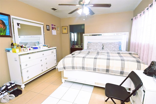 bedroom with light tile patterned flooring, visible vents, and a ceiling fan