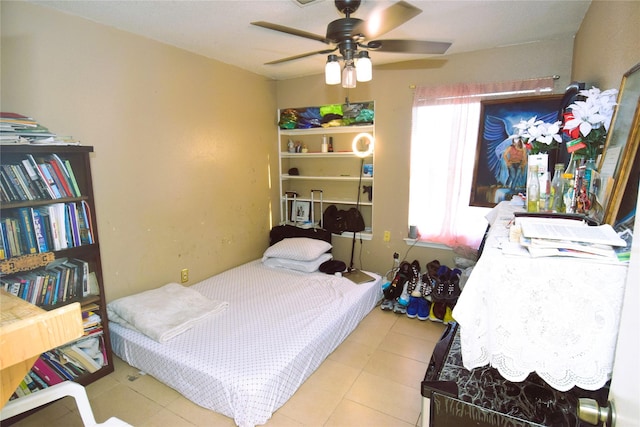 bedroom featuring a ceiling fan and tile patterned flooring