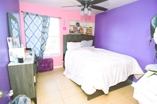 tiled bedroom featuring a ceiling fan