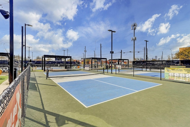 view of tennis court featuring fence