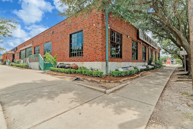 view of property exterior featuring brick siding