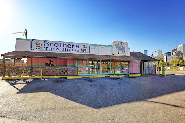 view of property with uncovered parking and fence