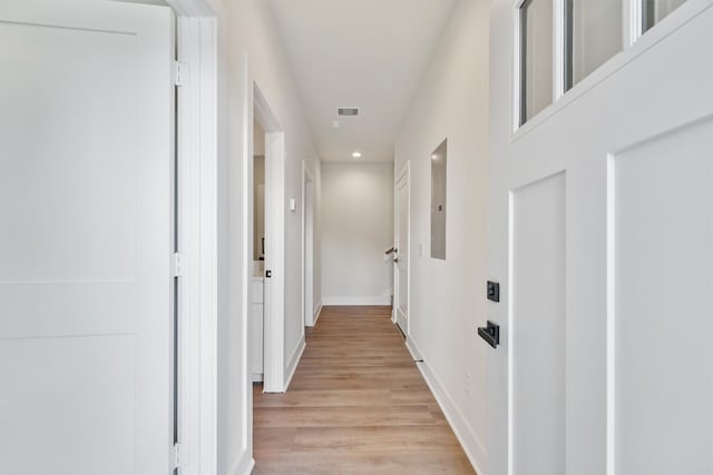 corridor with recessed lighting, visible vents, light wood-style flooring, and baseboards