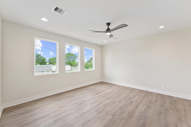 empty room featuring recessed lighting, baseboards, visible vents, and light wood finished floors