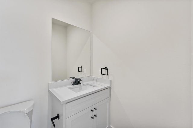 bathroom with toilet and vanity