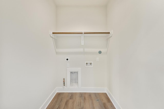 laundry area featuring light wood-type flooring, hookup for an electric dryer, gas dryer hookup, hookup for a washing machine, and laundry area