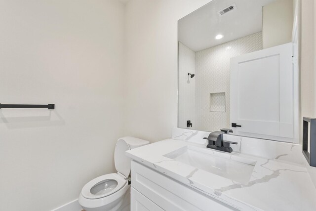 bathroom with visible vents, toilet, and vanity