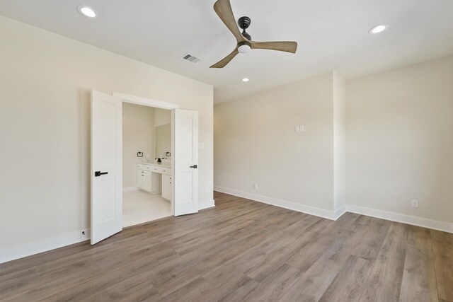 unfurnished bedroom featuring baseboards, recessed lighting, visible vents, and light wood-type flooring