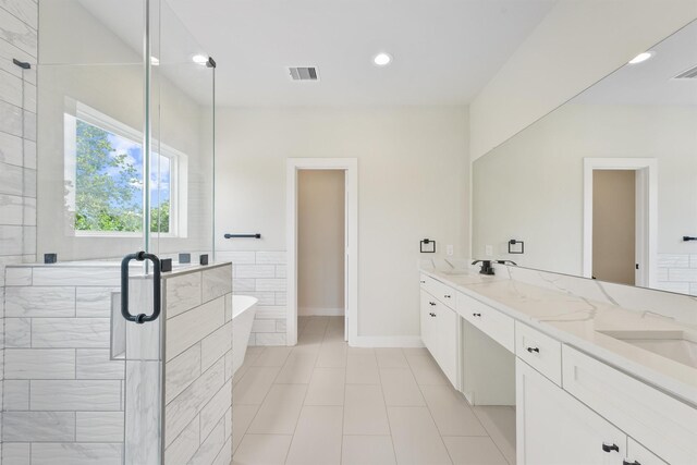 full bath featuring visible vents, double vanity, recessed lighting, a freestanding bath, and a shower stall