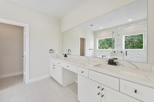 bathroom featuring visible vents, a shower stall, double vanity, tile patterned floors, and a sink