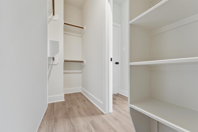 walk in closet featuring light wood finished floors