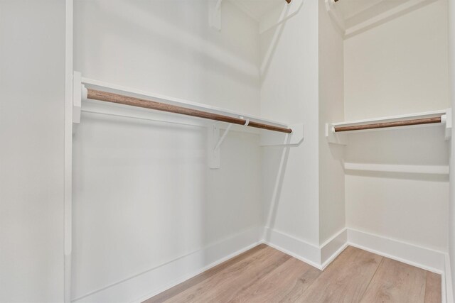 spacious closet with wood finished floors