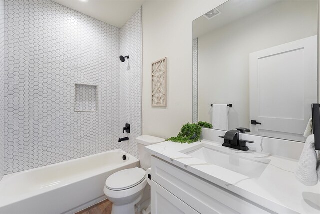 full bathroom featuring visible vents, vanity, toilet, and shower / bathtub combination