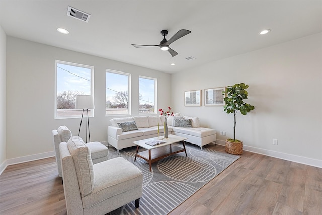 living room with recessed lighting, wood finished floors, visible vents, and baseboards