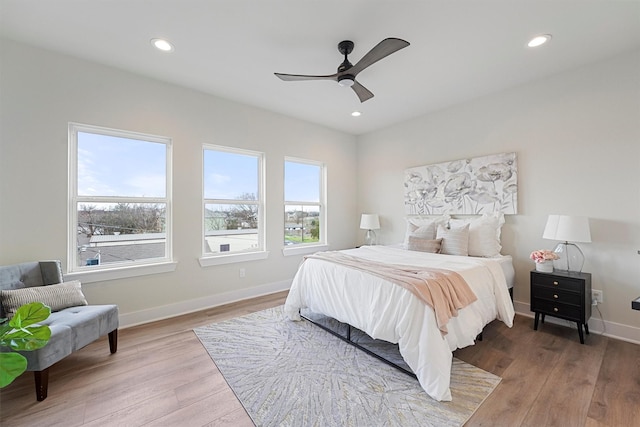 bedroom featuring recessed lighting, light wood-style floors, and baseboards