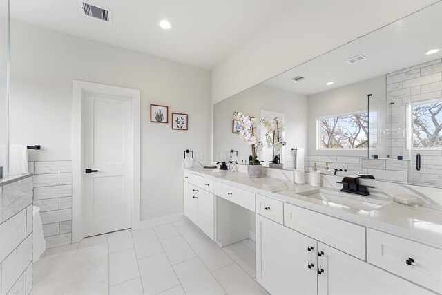 full bath with visible vents, recessed lighting, and a sink