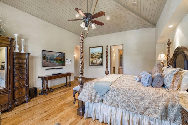 bedroom with arched walkways, wood ceiling, baseboards, and wood finished floors