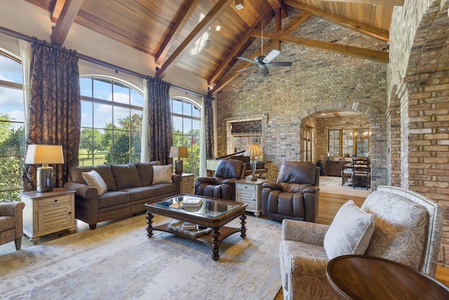 living area featuring brick wall, high vaulted ceiling, arched walkways, wooden ceiling, and beamed ceiling