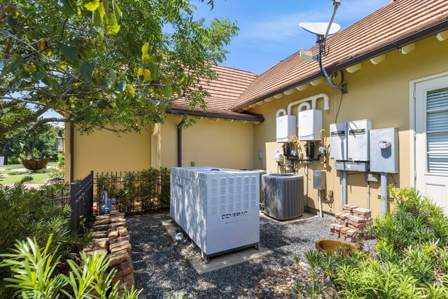 view of patio featuring fence and central AC