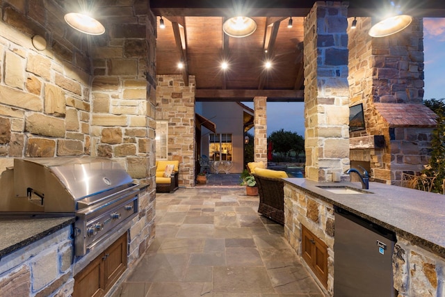 view of patio / terrace featuring an outdoor kitchen, a grill, and a sink