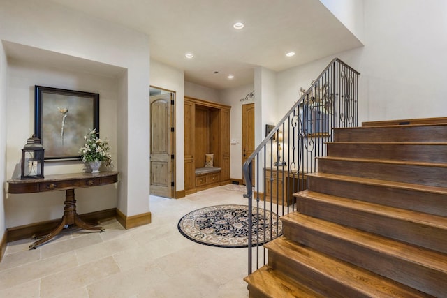 entrance foyer featuring recessed lighting, stairs, and baseboards