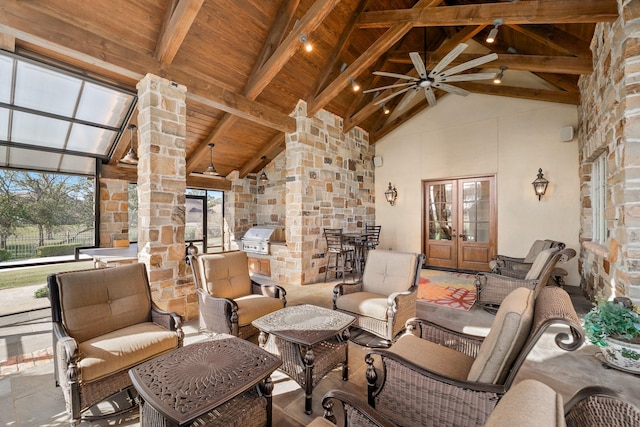 interior space featuring a ceiling fan, an outdoor kitchen, an outdoor living space, french doors, and a grill